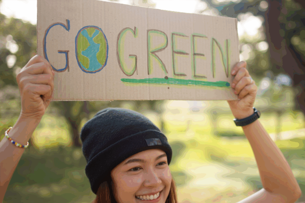 Go green Gen Z woman asia young people smile looking at camera showing save the earth planet world care banner poster sign in city nature tree public park. Protect future asian hope net zero waste.